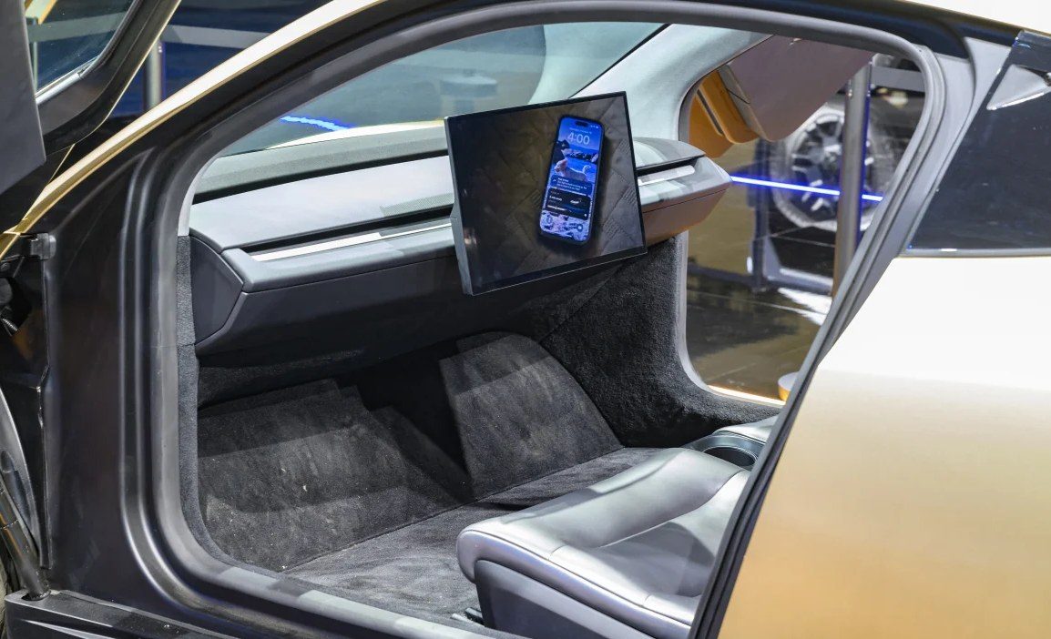 The interior of a Tesla Cybercab, with no steering wheel and no pedals