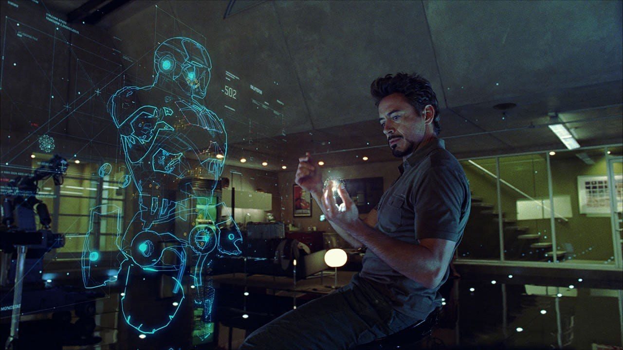 Tony Stark in his workshop, working with a holographic display